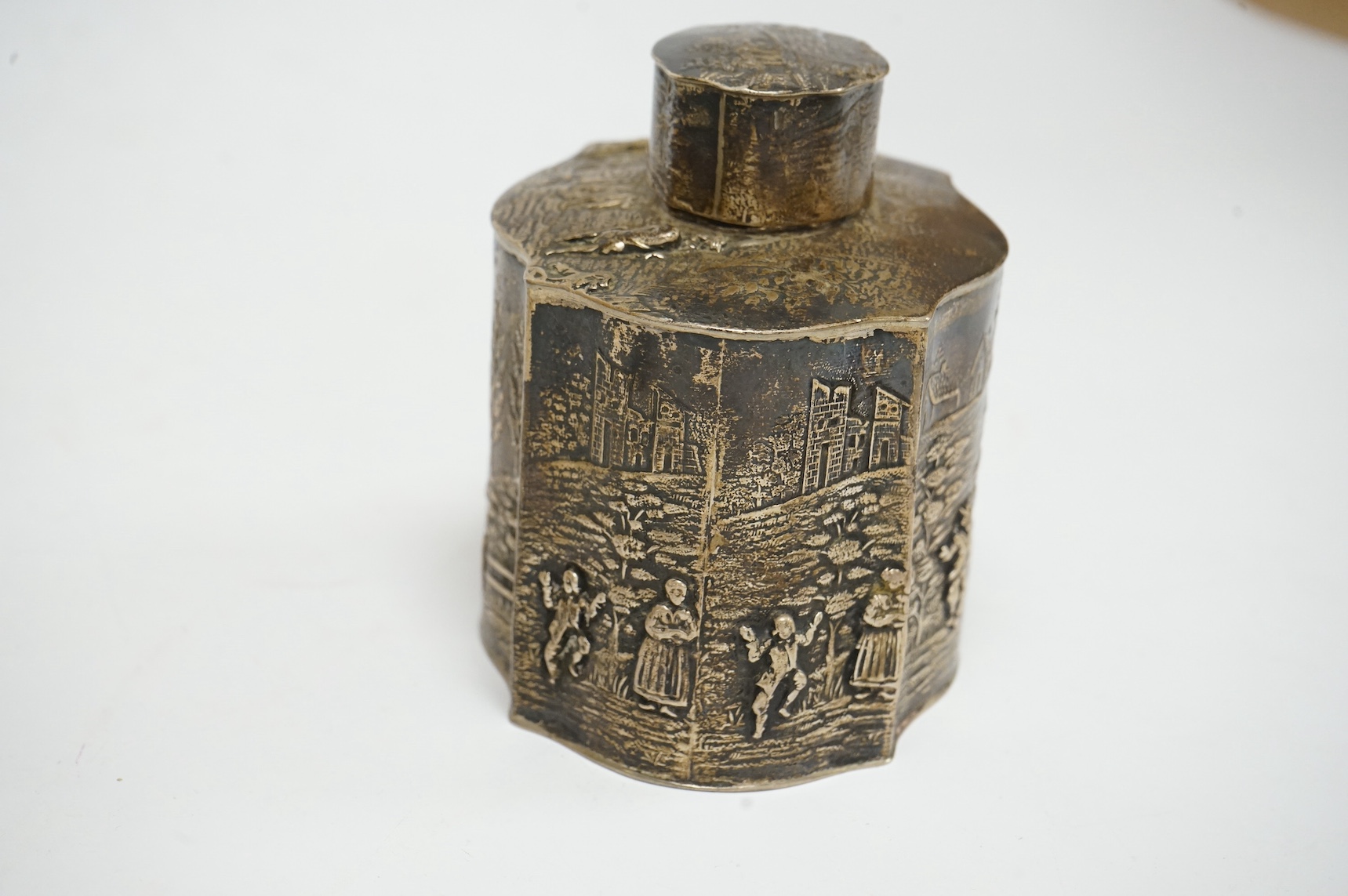 A George V embossed silver serpentine tea caddy, by HF, Chester, 1911, height 98mm, 6.3oz. Condition - fair
